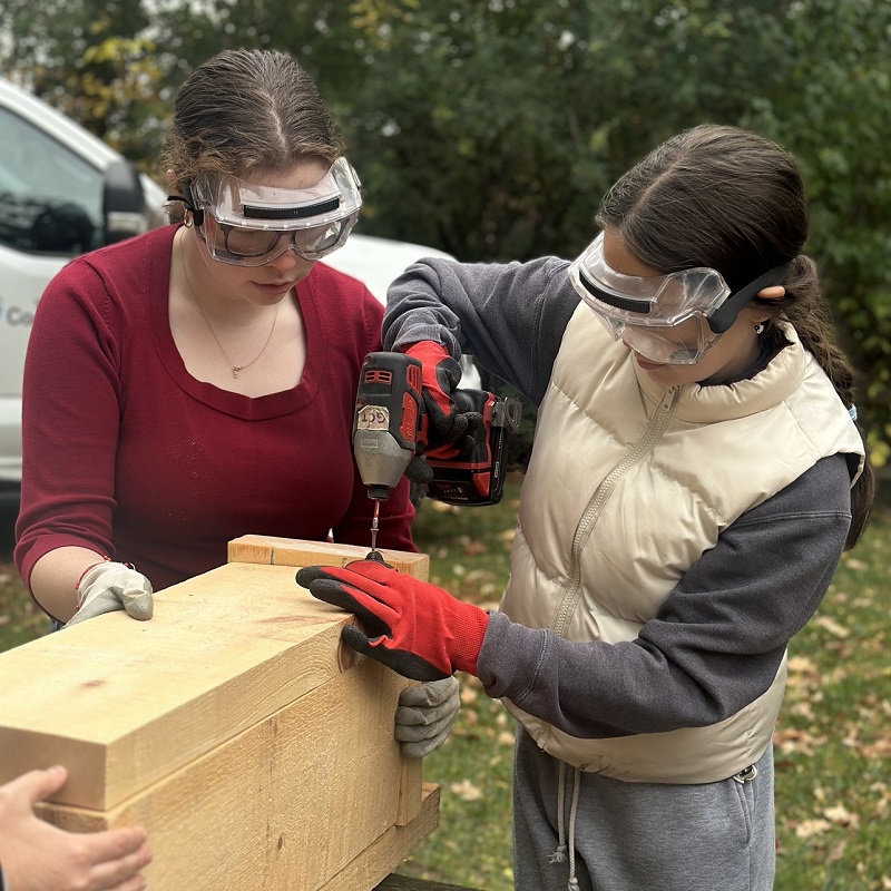 Girls Can Too program participants take part in a building project
