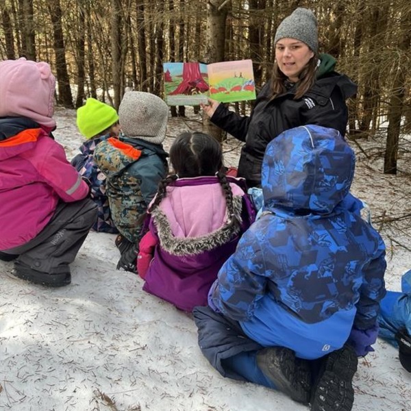 a teacher leads an outdoor story session at a March Break camp at Lake St George Field  Centre