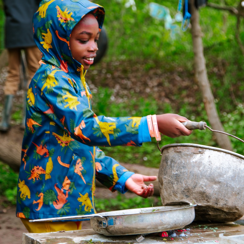 a student enjoys outdoor learning and adventure at The Nature School at Claireville Conservation Area in Brampton