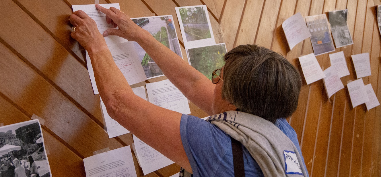 a neighbourhood resident take part in a brainstorming exercise at a SNAP community pop-up event