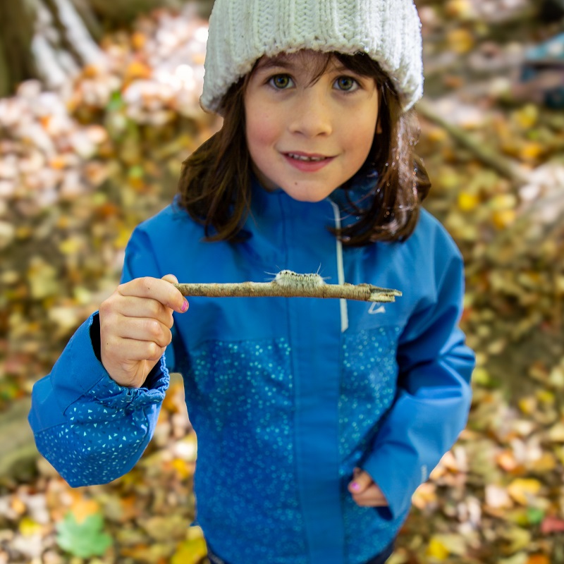 a student enjoys outdoor learning and adventure at The Nature School at Claremont Nature Centre in Pickering