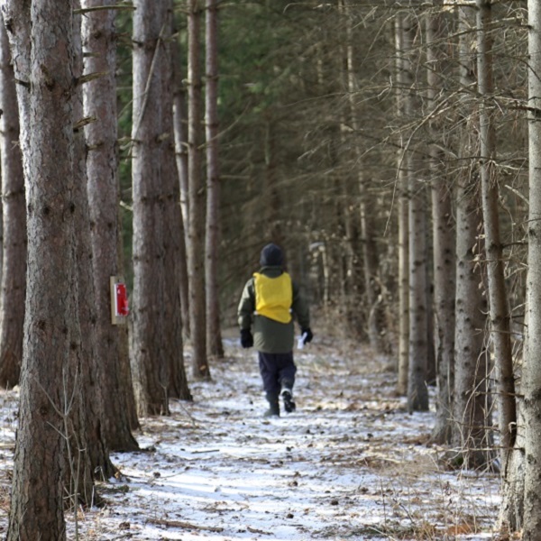 a student explores a forest trail during a TRCA March Break Camp at Albion Hills Conservation Park in Caledon