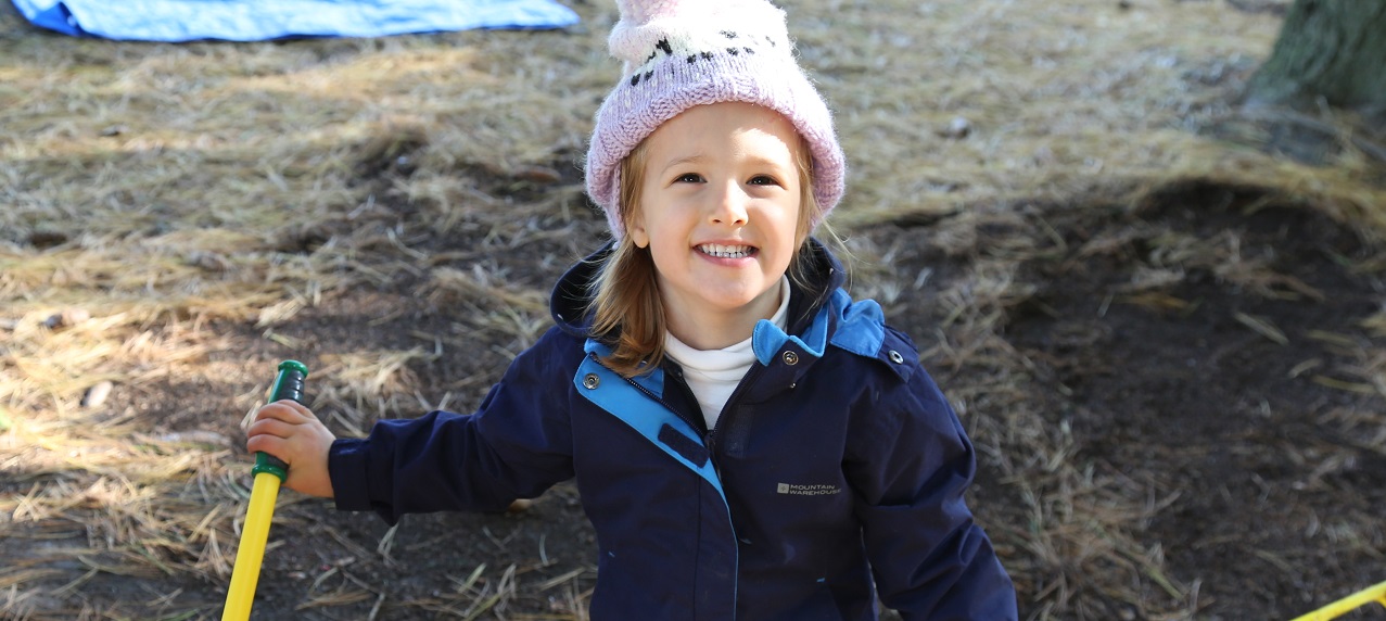 a pre-schooler enjoys guided outdoor play in the Beyond the Park - Forest Friends program