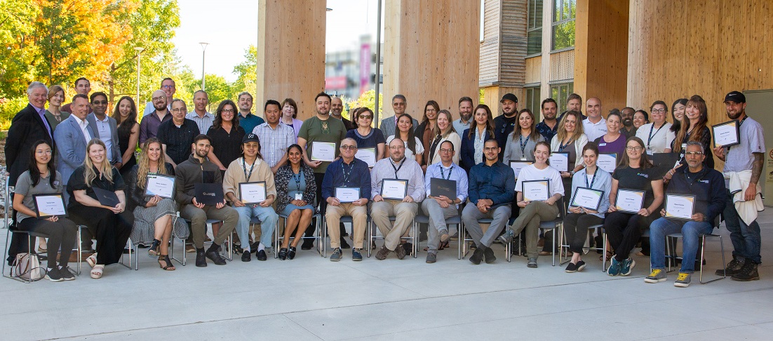 TRCA 2025 service recognition award recipients gather for a group photograph outside the administrative office building