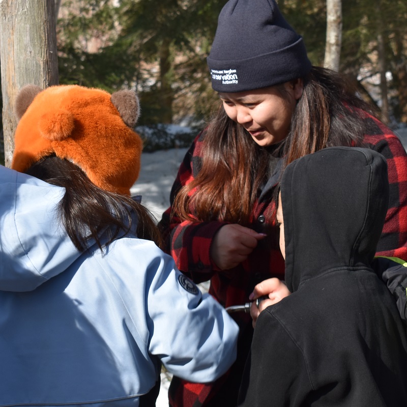 a TRCA team member greets youngsters at the annual Maple Syrup Festival at Kortright Centre for Conservation in Vaughan