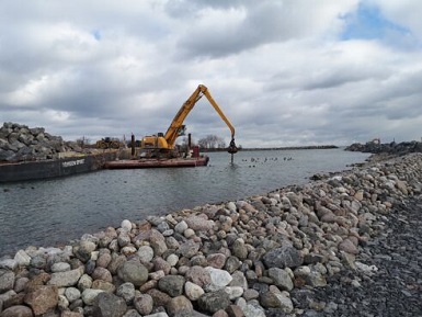 Excavator placing trees in the sunken tree field habitat component
