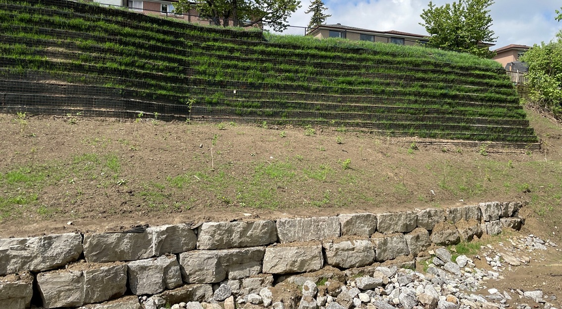 Mechanically stabilized earth wall and armourstone toe protection behind Topcliff Avenue