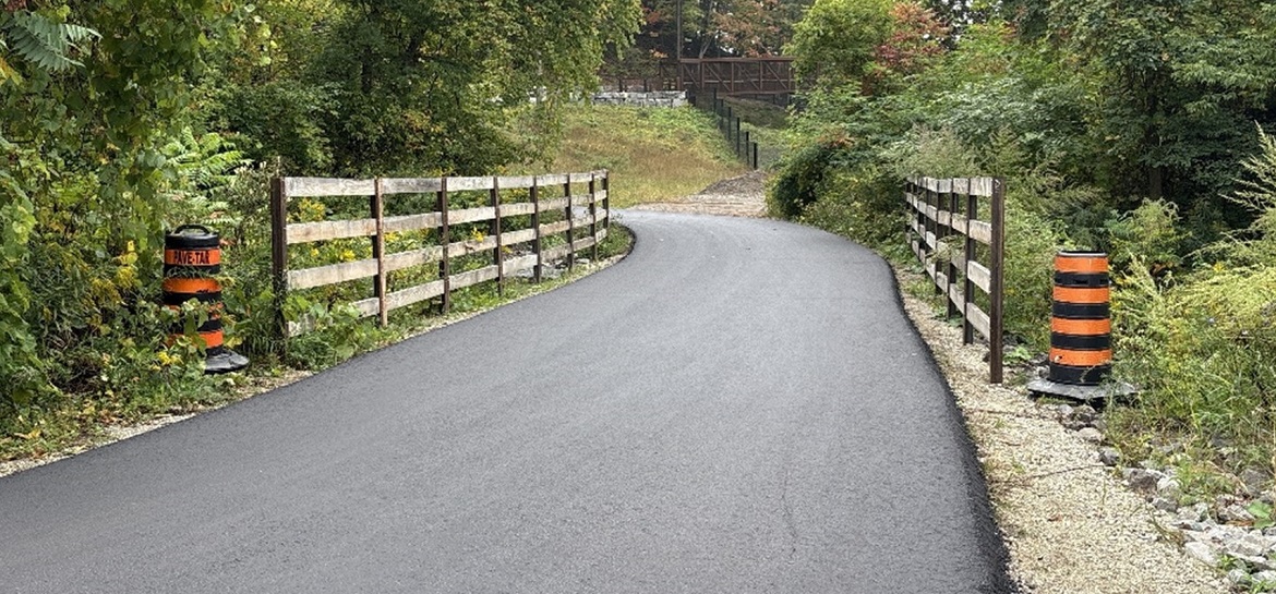 East Don Trail project - Asphalt paving across the creek crossing with Pedestrian-Cycle Overpass Bridge in the far distance