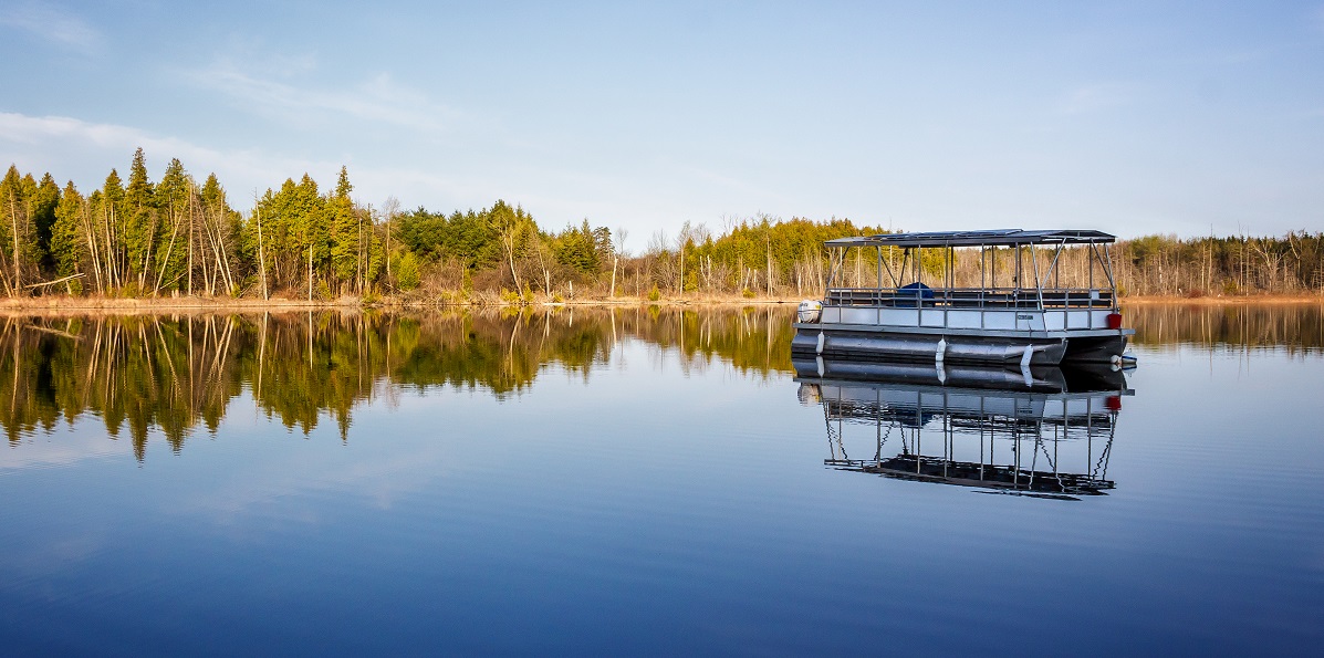 a pontoon boat on the still waters of Lake St George