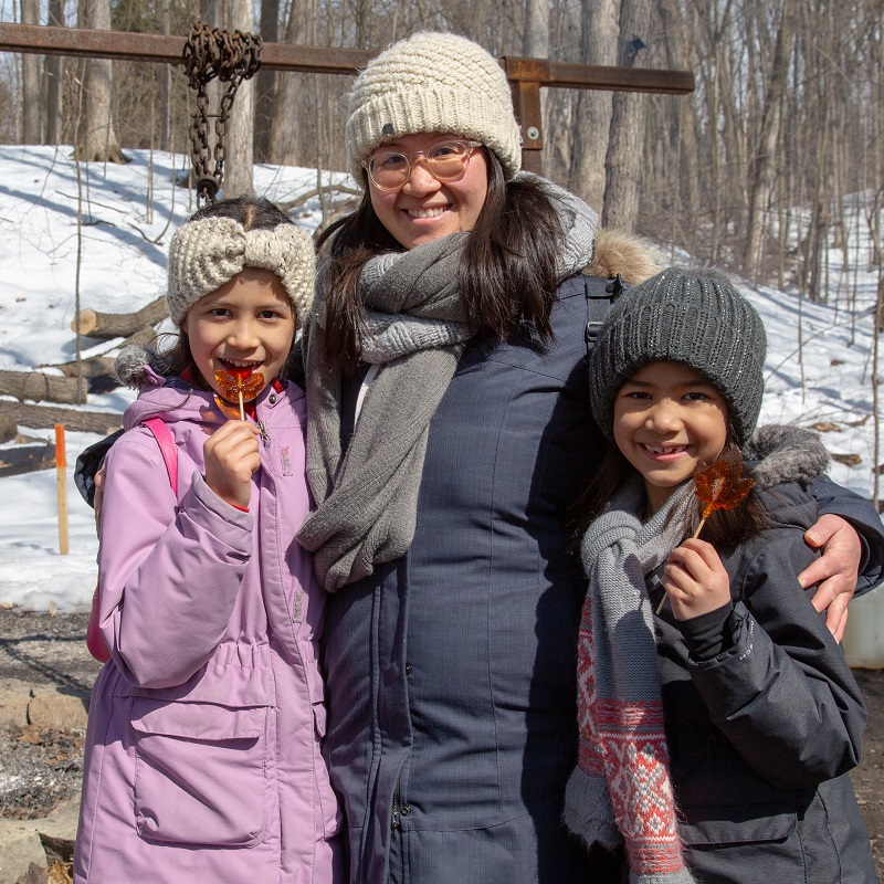 visitors to the Sugarbush Maple Syrup Festival at Kortright Centre for Conservation sample maple syrup treats