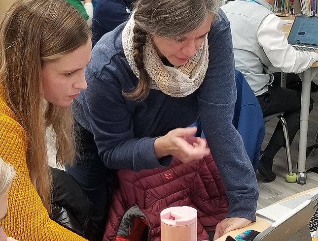 teacher and student work together on an EcoSchools project
