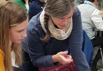 teacher and student work together on an EcoSchools project