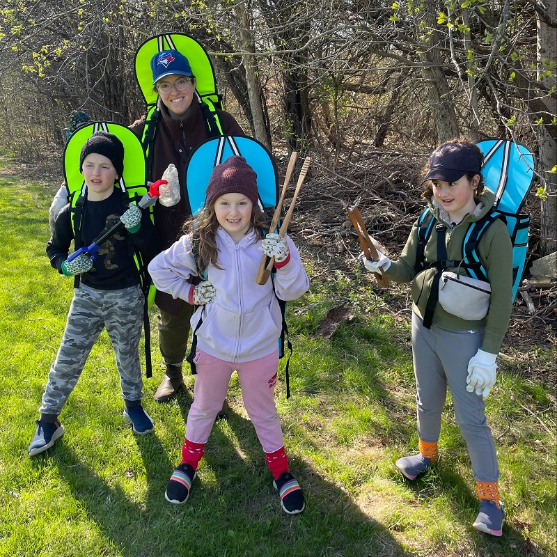 a young mother and children take part in an Earth Week clean-up event