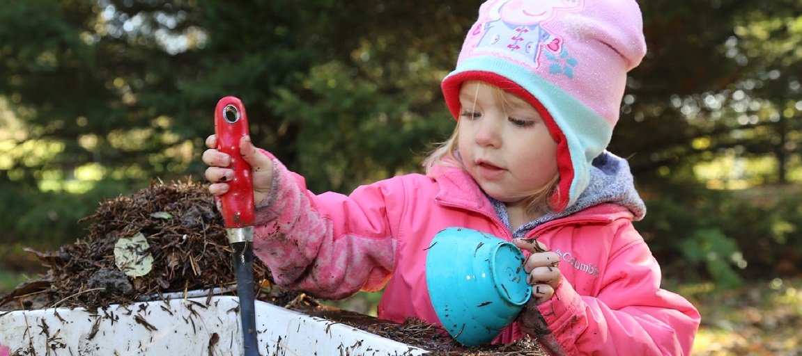 a toddler experiences outdoor learning and creative play in the Little Saplings program at Kortright Centre for Conservation