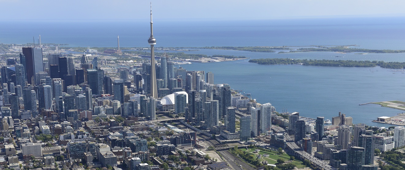 an aerial view of the Toronto skyline looking south over the Lake Ontario waterfront