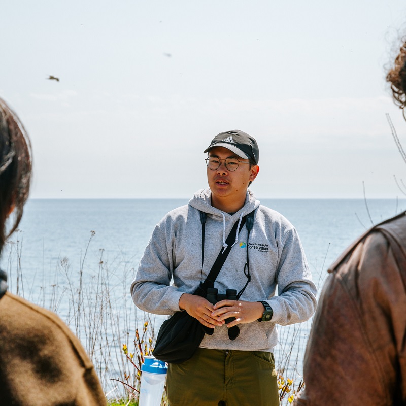 a TRCA team member leads a guided walk during the Spring Bird Festival at Tommy Thompson Park