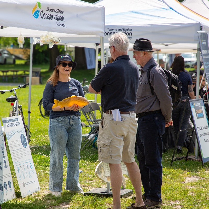 TRCA Board of Directors Vice Chair Paul Ainslie and a dignitary visit one of the interactive booths  at the Celebrate the Humber event