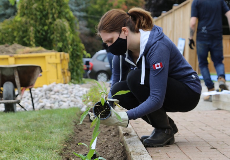 West Bolton SNAP neighbourhood resident plants a rain garden as part of a green home makeover project