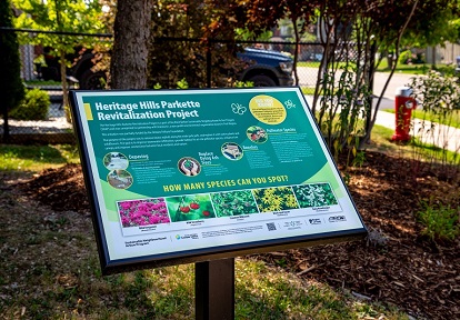 a new interpretive sign in the revitalized Heritage Hills Parkette in West Bolton