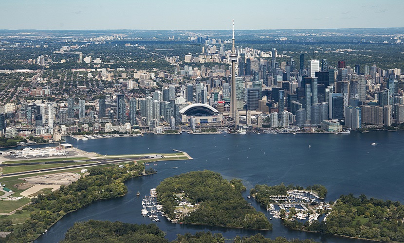 an aerial view of the Toronto skyline with Lake Ontario and Toronto Island in the foreground