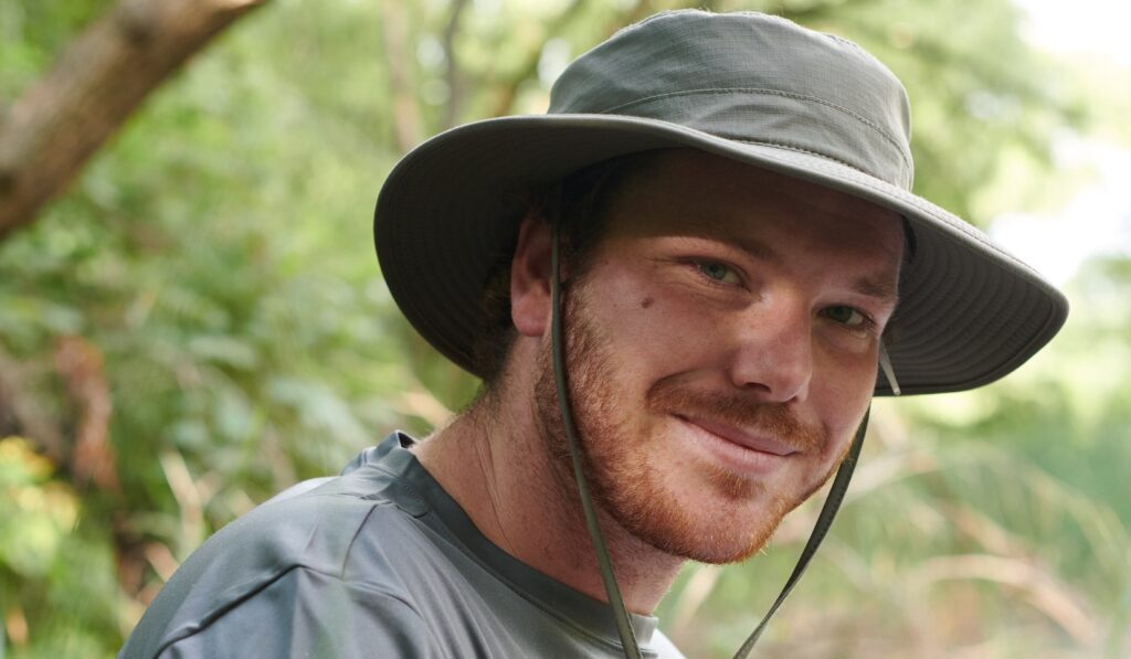 a student biologist conducts terrestrial habitat monitoring in the field