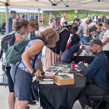 community members sign up for guided walks and other activities at the TRCA butterfly festival at Tommy Thompson Park