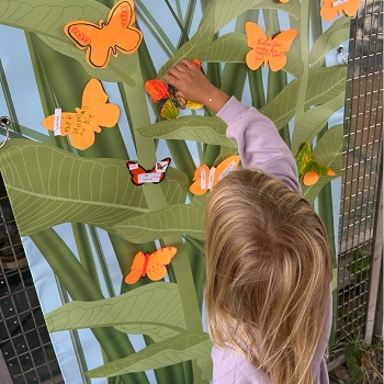 a young visitor enjoys interactive activities at an educational booth at the TRCA Butterfly Festival at Tommy Thompson Park