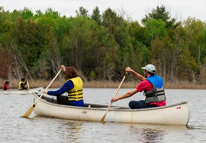paddlers canoeing at Lake St George on autumn day