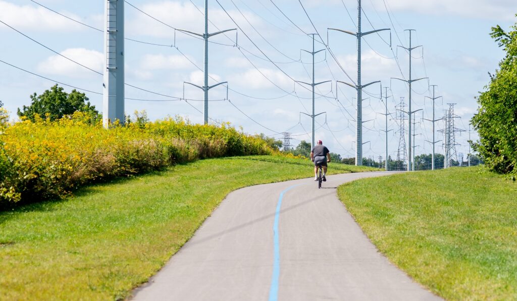 a cyclist explores the newly opened section 3 of The Meadoway
