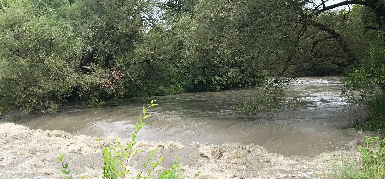 rising water levels in a local stream following a storm event