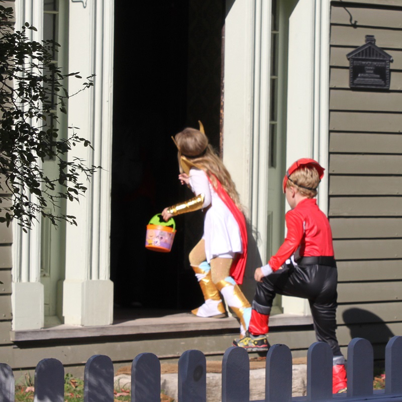children go trick-or-treating at a heritage building at The Village at Black Creek